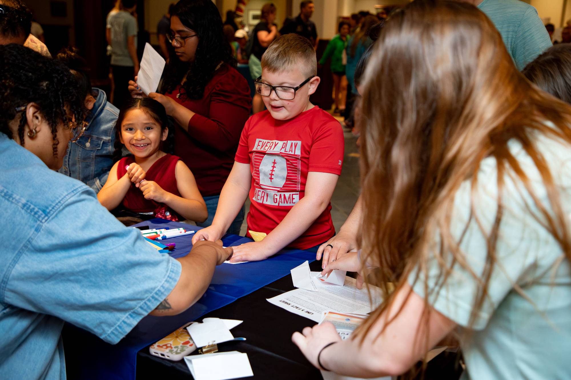 Two educators at their table showing their action project